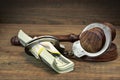 Dollar banknotes, handcuffs and judge gavel on wood table