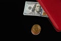 Dollar banknotes in red wallet and bitcoin coins isolated on black background Royalty Free Stock Photo