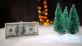 100 dollar bill and artificial Christmas trees. Christmas tree and one hundred dollar bills of dollar against the background of Royalty Free Stock Photo