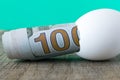 100 dollar bill in an egg shell. The concept of saving Royalty Free Stock Photo