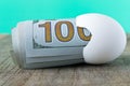 100 dollar bill in an egg shell. The concept of saving Royalty Free Stock Photo