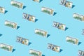 100 dollar bill izometric pattern on bright light blue background.