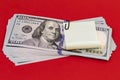 100 dollar bills with black paper clip and sticker paper on red background Royalty Free Stock Photo