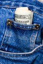 Dollar bills in blue jeans