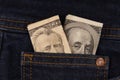 50 and 100 dollar bills in blue jeans pocket Royalty Free Stock Photo