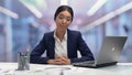 Dollar bills falling around young self-determined businesslady looking to camera