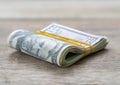 Dollar bills folded and tied with yellow rubber band Royalty Free Stock Photo