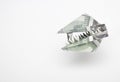 Dollar bills in the form of an animal`s head with sharp teeth, origami on a white background. The concept of the economic financia Royalty Free Stock Photo