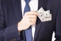 Dollar bills in a jacket pocket of a businessman. Hand takes out a note of the American dollar from a pocket of a jacket Royalty Free Stock Photo