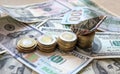 Dollar bills laid out on table. A dollar boat on the highest column of coins, four columns of coins, financial crisis Royalty Free Stock Photo