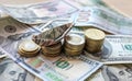 Dollar bills laid out on table. A dollar boat on the middle column of coins, four columns of coins, financial crisis Royalty Free Stock Photo