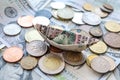 Dollar bills laid out on table. Scattered coins on dollars, dollar bill boat, financial crisis, ukrainian kopecks, uk