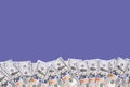 100 dollar bills wiggle on purple or violet background. Banner about money with copy space Royalty Free Stock Photo