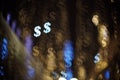 Dollar bokeh on city streets. Abstract financial background with many dollar symbols Royalty Free Stock Photo