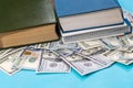 Dollar and book on blue Royalty Free Stock Photo