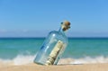 10 dollar in a bottle on the beach Royalty Free Stock Photo