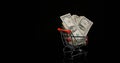 Dollar Coins in Trolley rolling against Black Background