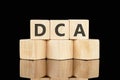 Dollar cost averaging DCA text on wooden cubes on a black background Royalty Free Stock Photo