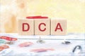 Dollar cost averaging DCA text it is written on wooden cubes on a colored background Royalty Free Stock Photo