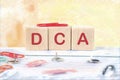 Dollar cost averaging DCA text it is written on wooden cubes on a colored background