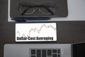 Dollar-Cost Averaging investment. Top view of stocks price candlestick chart in phone on table near laptop, notepad and glasses