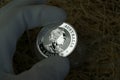 1 dollar Elizabeth II. Australian pure silver investment coin. A silver coin in the hands of an appraiser.