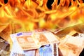 Dollar and euro bills on fire Royalty Free Stock Photo