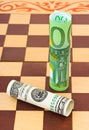 Dollar and euro on chess board Royalty Free Stock Photo