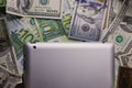 Dollar and euro money, tablet, cell phone close up.