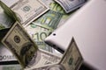 Dollar and euro money, tablet, cell phone close up. Royalty Free Stock Photo