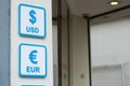 Dollar and euro signs. Written in blue on white signboard