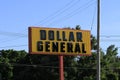 A Dollar General Advertisement sign with tree`s and blue sky on a colorful day in Kansas Royalty Free Stock Photo