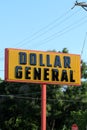 A Dollar General Advertisement sign with tree`s and blue sky on a colorful day in Kansas Royalty Free Stock Photo