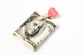 Dollar and a heart on a white background. Love for money, donations concept