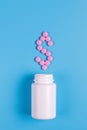 Dollar icon with pink pills and white bottle on blue background Royalty Free Stock Photo