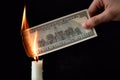 Dollar inflation and world financial crisis concept, 100 dollars banknote burns in fire, depreciation of money