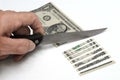 US One Dollar bill being cut with knife Royalty Free Stock Photo