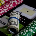 A 100 dollar kupurs is on the blackjack table next to poker chips and a dealer's chip Royalty Free Stock Photo