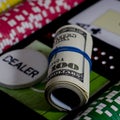 A 100 dollar kupurs is on the blackjack table next to poker chips and a dealer's chip Royalty Free Stock Photo