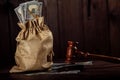 Dollar money bag and judge's gavel. Litigation, dispute resolution, conflict of interest settlement Royalty Free Stock Photo