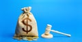 Dollar money bag and judge`s gavel. Litigation, dispute resolution, conflict of interest settlement. Awarding moral financial Royalty Free Stock Photo