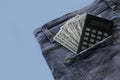 Dollar money and calculator in a pocket of blue jeans Royalty Free Stock Photo