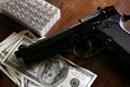 Dollar notes and gun, black pistol Royalty Free Stock Photo