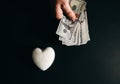 Dollar notes with a heart. Money addicted and consumerism. Love for sale