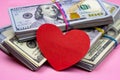 Dollar packs and big red paper heart on money background. Sex, love and prostitution concept. Royalty Free Stock Photo