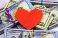 Dollar packs and big red paper heart on money background. Sex, love and prostitution concept. Royalty Free Stock Photo