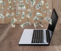 Dollar pouring out from a notebook computer Royalty Free Stock Photo