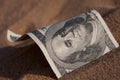 Dollar in the sand Royalty Free Stock Photo