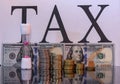 Dollar with sand clock and word tax with reflection Royalty Free Stock Photo