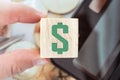 Dollar sign letterpress design on wooden cube decorate with calculator stationary gold coin. Business financial investing home Royalty Free Stock Photo